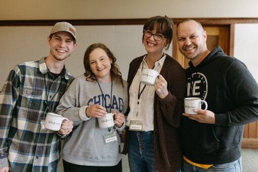 Group of people holding coffee mugs