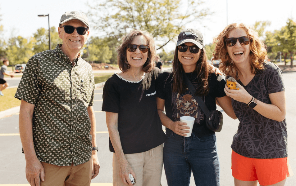 Four adults smiling